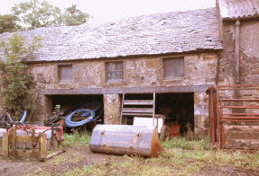 Click to Enlarge:  Ancient building makes rightangle with arched stable block.